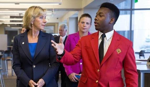 Marc Aristide talking with Betsy DeVos